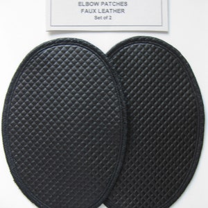 May include: Two black faux leather elbow patches with a quilted diamond pattern. The patches are oval shaped and have a stitched edge. The label reads "CRAFT ♥ T'S ELBOW PATCHES FAUX LEATHER Set of 2".