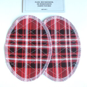 May include: Set of two red, black, and white plaid elbow patches. The patches are oval shaped and have a white stitched edge. The text on the card reads "CRAFT ♥ T'S PLAID, HOUNDSTOOTH, OR HERRINGBONE ELBOW PATCHES SET OF 2".