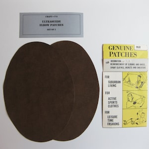 May include: Two brown ultrasuede elbow patches, a set of two, on a white background. The packaging says "Craft-T's Ultrasuede Elbow Patches Set of 2" and "Genuine Patches Pair".