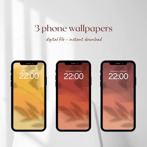 Può includere: Tre schermi di smartphone che mostrano sfondi digitali con una calda tavolozza di colori. Gli schermi mostrano una sfumatura di tonalità gialle, arancioni e rosse, con l'ora 22:00 visualizzata. Il testo "3 phone wallpapers digital file - instant download" è in alto.