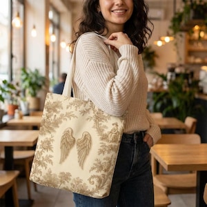 Vintage toile tote bag with angel wings and beige botanical print, rustic French country tote in vintage cottagecore style.