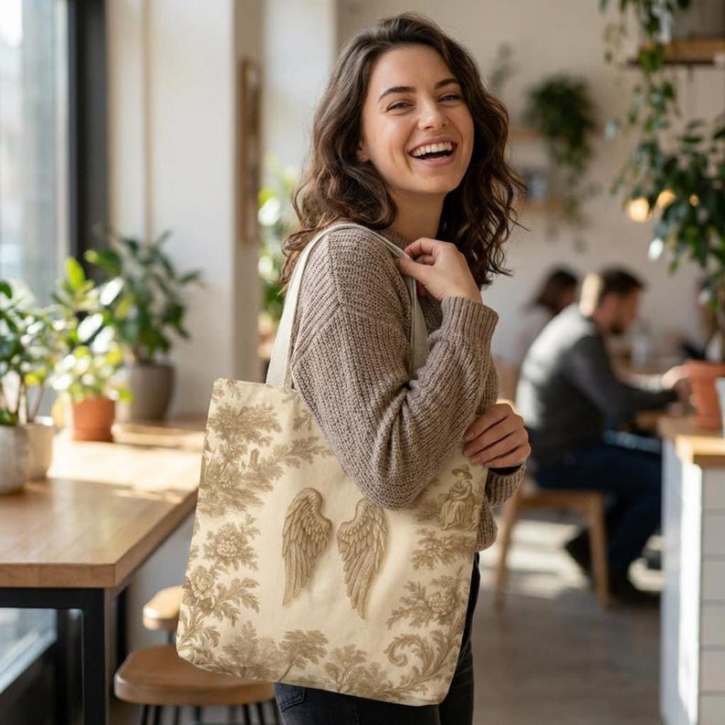 Vintage toile tote bag with angel wings and beige botanical print, rustic French country tote in vintage cottagecore style.