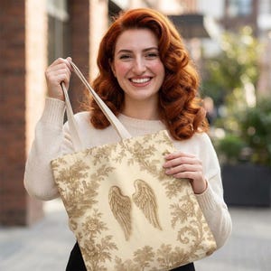 Vintage toile tote bag with angel wings and beige botanical print, rustic French country tote in vintage cottagecore style.