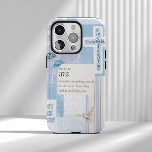 May include: A light blue phone case with a collage design. The case features a cross, a dove, and the text "PSALM 37:5" with a Bible verse. The case has a glossy finish and is designed to fit a smartphone.