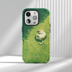 May include: Green phone case featuring a cartoon illustration of a sleeping cat on grass. The design includes a light green background with white flowers and shadows, creating a serene, nature-inspired aesthetic. The case has a black border.