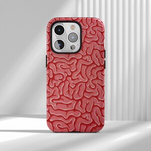 May include: A phone case featuring a red brain pattern design. The case has a glossy finish and a black border. The design is a detailed illustration of a human brain, with the characteristic folds and crevices.