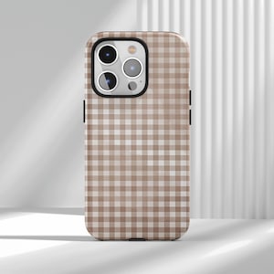 May include: A phone case with a brown and white gingham pattern. The case has a black border and cutouts for the camera and buttons. The case is designed to fit a smartphone.