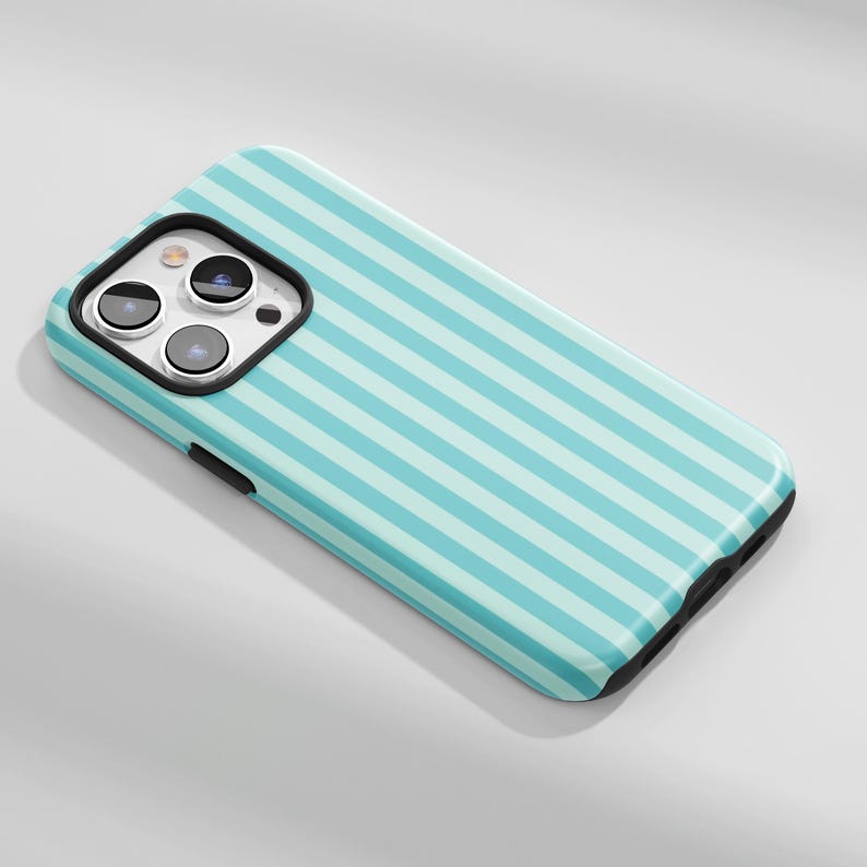 May include: A smartphone case with a light blue and white striped pattern. The case has a black border and a camera cutout with three lenses. The case is designed to fit a smartphone.
