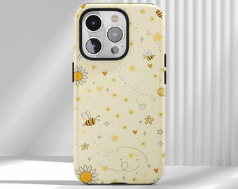 May include: A light yellow phone case with a repeating pattern of bees, stars, hearts, and flowers. The case has a black border and a camera cutout. The design is whimsical and cheerful.