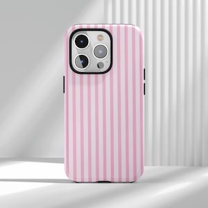 May include: Pink and white striped phone case. The case has a black border and covers the back and sides of the phone. The case has cutouts for the camera and buttons.