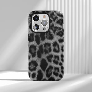 May include: A smartphone case with a black and gray leopard print design. The case has a glossy finish and features cutouts for the camera and buttons. The leopard print pattern is detailed and covers the entire back of the case.