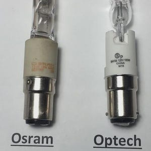 May include: Two clear glass light bulbs with metal bases are displayed. One is labeled "Osram" with the numbers 64485/64475, and the other is labeled "Optech" with the number 64485. Both bulbs have a wattage of 100W and are designed for 120V.