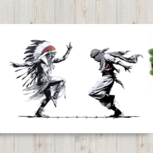 May include: Black and white print of two figures dancing. One figure wears a feathered headdress with red accents, the other wears a head covering and flowing garments. The artwork is displayed on a white canvas against a wood-grain background.