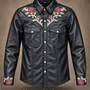 May include: A black leather shirt featuring gold-tone snap buttons, two chest pockets, and embroidered red rose motifs with cream-colored stems on the shoulders and cuffs. The collar displays a size M tag. The text Vevouge Leather Co is visible.