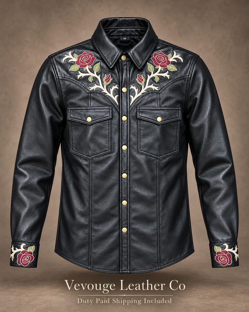 May include: A black leather shirt featuring gold-tone snap buttons, two chest pockets, and embroidered red rose motifs with cream-colored stems on the shoulders and cuffs. The collar displays a size M tag. The text Vevouge Leather Co is visible.