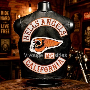 May include: A black leather vest featuring a large embroidered patch on the back. The patch displays the text HELLS ANGELS in an arc above a winged skull emblem, with the text CALIFORNIA below and a smaller MC patch in the center.