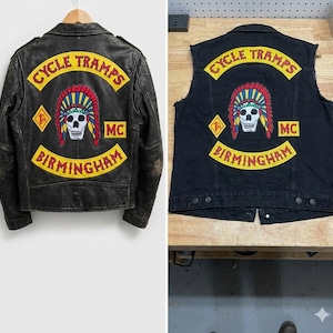 May include: Black leather motorcycle jacket and a black denim vest. Both feature a yellow patch with "CYCLE TRAMPS" and "BIRMINGHAM" text, and a skull wearing a Native American headdress. The jacket is worn, while the vest is sleeveless.