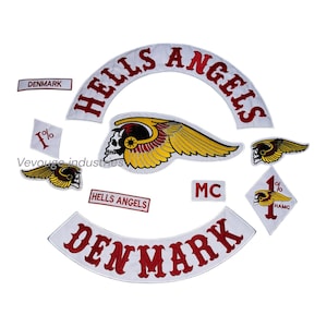 May include: A collection of embroidered patches featuring the words "HELLS ANGELS" and "DENMARK" in red lettering on a white background. Includes a skull with wings and the text "1%" and "MC".