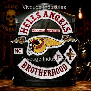 May include: A black leather vest featuring large embroidered patches. The back displays the text HELLS ANGELS and BROTHERHOOD in red, a central winged skull emblem, two small winged skull patches, an MC patch, and two diamond-shaped 1% patches.