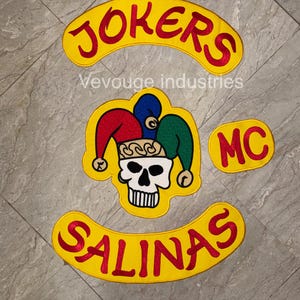 May include: A set of yellow and red embroidered patches. The patches include the word "JOKERS" in red, a skull wearing a jester's hat, the word "SALINAS" in red, and the letters "MC". The text "Vevouge industries" is also present.