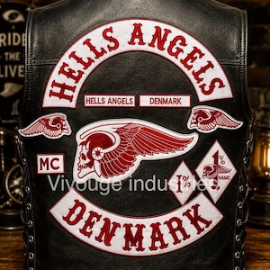 May include: A black leather vest featuring white and red embroidered patches. The back displays the text HELLS ANGELS, DENMARK, and MC, along with a winged skull emblem, two smaller winged skull patches, and two diamond-shaped 1% patches.
