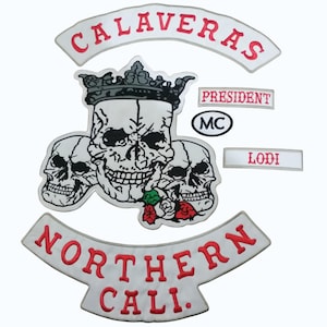 Pode incluir: Conjunto de patches bordados com uma caveira coroada, rodeada por duas outras caveiras, e as palavras "CALAVERAS" e "NORTHERN CALI." em vermelho. Inclui patches "PRESIDENT", "MC" e "LODI".