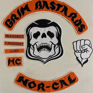 May include: A set of embroidered patches with a biker theme. The patches display the words "GRIM BASTARDS" and "NOR-CAL" in black lettering on orange arched backgrounds. Other patches include a skull, a clenched fist, and text that reads "PRESIDENT", "V.PRESIDENT", "LODI", and "MC".