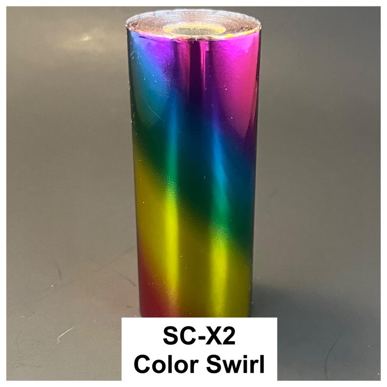 May include: A roll of iridescent vinyl with a color swirl effect. The colors transition from pink to blue, green, and yellow. The text "SC-X2 Color Swirl" is displayed on a white rectangle at the bottom.