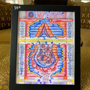 May include: A framed artwork with a black border. The colourful abstract design features a tent-like shape and a series of eye-like figures. The artwork is filled with intricate patterns and details, using a palette of red, blue, and yellow.