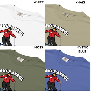 May include: Four t-shirts in white, khaki, moss green, and mystic blue. Each shirt features the words "SKI PATROL" above a cartoon skier in a red jacket and black pants. The shirts are made of a soft, comfortable material.