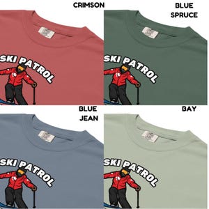 May include: Four t-shirts in crimson, blue spruce, blue jean, and bay colors. Each shirt features a crew neck and a "SKI PATROL" graphic with a skier in a red jacket. The shirts are made of a soft material.