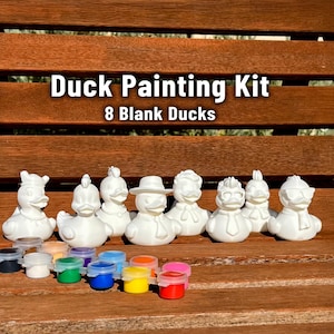 May include: A Duck Painting Kit with eight blank white duck figurines, each with a unique design. The kit includes small paint pots in various colors. Text on the image reads "Duck Painting Kit" and "8 Blank Ducks".