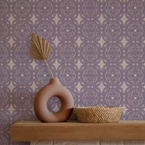 May include: A decorative display featuring a brown vase with a circular opening, a woven basket, and a dried palm leaf on a wooden shelf. The background is a patterned wallpaper in shades of purple and beige, creating a warm, inviting aesthetic.