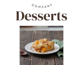 May include: A cookbook cover featuring a dessert recipe. The title reads "The Savory Kitchen Company" with the word "Desserts" in large, dark brown letters. A slice of peach cobbler sits on a white plate, with a wooden spoon and green cloth nearby.