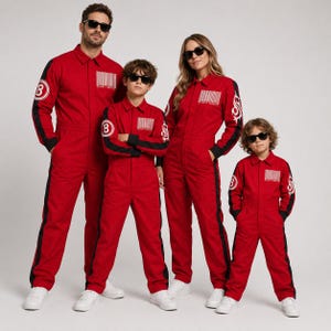 May include: Matching red jumpsuits with black side stripes, a white barcode graphic on the chest, and a circular logo with the number 8 on the right sleeve. Each jumpsuit features a collared neckline, long sleeves, and a front zipper closure.