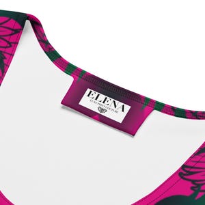 Close-up of the interior collar label reading ELENA Luxe Print Couture inside the hot pink dress.