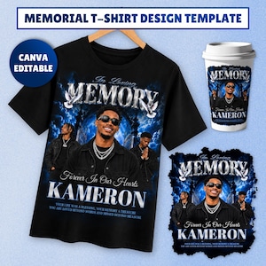 May include: A black t-shirt featuring a memorial design with a central photograph of a person wearing sunglasses and chains, surrounded by blue clouds, an archway, and white doves. The text reads In Loving Memory, Forever In Our Hearts, and KAMERON.