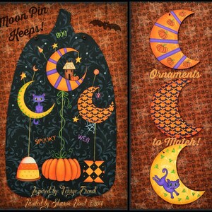 May include: A set of Halloween-themed moon ornaments. The ornaments are painted in orange, black, purple, and yellow with various patterns. The ornaments feature a cat, a spider, a pumpkin, and a house. The text "Moon Pin Keeps!" and "Ornaments to Match!" is visible in the image.