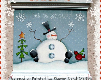 May include: A hand-painted wooden sign with a snowman, a Christmas tree, and a cardinal. The sign reads "Let it Snow!" and "Let it snow!" in a whimsical font. The background is a light blue with white snowflakes. The sign is framed with a white border and has a white base with the text "Designed & Painted by Sharon Bond (c) 2014".