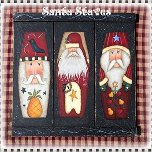 May include: Three painted wooden Santa Claus figures, each with a different design. The figures are painted in red, white, and green with black outlines. The figures are arranged in a row on a black background. The text "Santa Staves" is written above the figures.