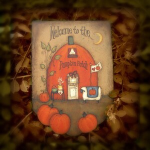 May include: A decorative, rectangular sign with a pumpkin patch theme. The sign features an orange pumpkin-shaped building with a door, a flag with hearts, and the text "Welcome to the Pumpkin Patch." Several orange pumpkins are in the foreground.