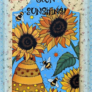 May include: A blue wooden sign with the text "Make Your Own Sunshine!" painted on it. The sign is decorated with sunflowers, bees, and a beehive.