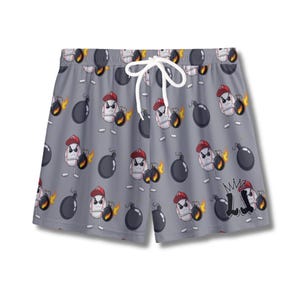 May include: Gray swim trunks with a repeating pattern of cartoon baseballs wearing red caps and holding lit bombs. The shorts have a white drawstring and the letters "LJ" are printed on the lower right.