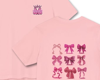 May include: Pink t-shirt with a small crown logo and the text "LEGENDLINE" on the upper left. The back of the shirt features a grid of nine pink bows in various designs and shades.