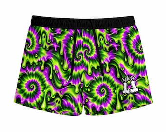 May include: Athletic shorts featuring a vibrant tie-dye pattern in neon green and purple with a dripping slime effect. The shorts have a black elastic waistband with black drawstrings and a white logo with a crown icon on the lower right leg.