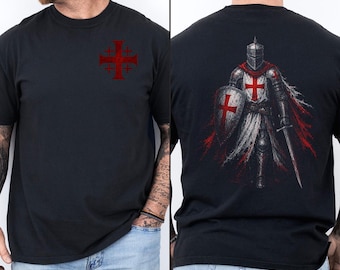 May include: A black short-sleeve t-shirt featuring a red Jerusalem cross graphic on the left chest. The back of the shirt displays a detailed illustration of a medieval knight in full armor, holding a shield and sword, adorned with red crosses.