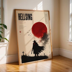 May include: A rectangular poster in a thin gold frame featuring the text HELLSING and Japanese characters. The artwork displays a silhouette of a figure in a long coat and hat standing in a graveyard beneath a large, textured red sun and birds.