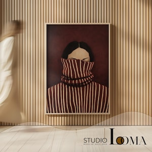 May include: A framed rectangular wall art print featuring a portrait of a person with dark hair wearing a high-neck, dark red and white striped sweater that covers the lower half of their face. The background is a solid deep maroon color.