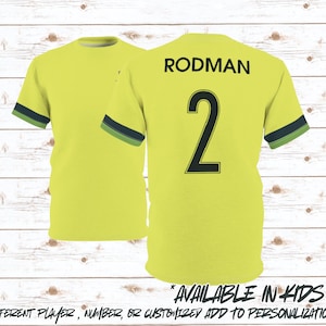 May include: Two yellow soccer jerseys with the name "RODMAN" and the number "2" on the back. The sleeves have a navy and green stripe. The text "AVAILABLE IN KIDS SIZES" is at the bottom.