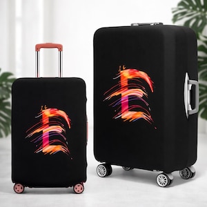 May include: Two black suitcase covers featuring a vibrant, abstract "E" design in red, orange, and purple. The "E" has a brushstroke effect. One cover is on a smaller suitcase with a handle, the other on a larger suitcase with a handle and wheels.